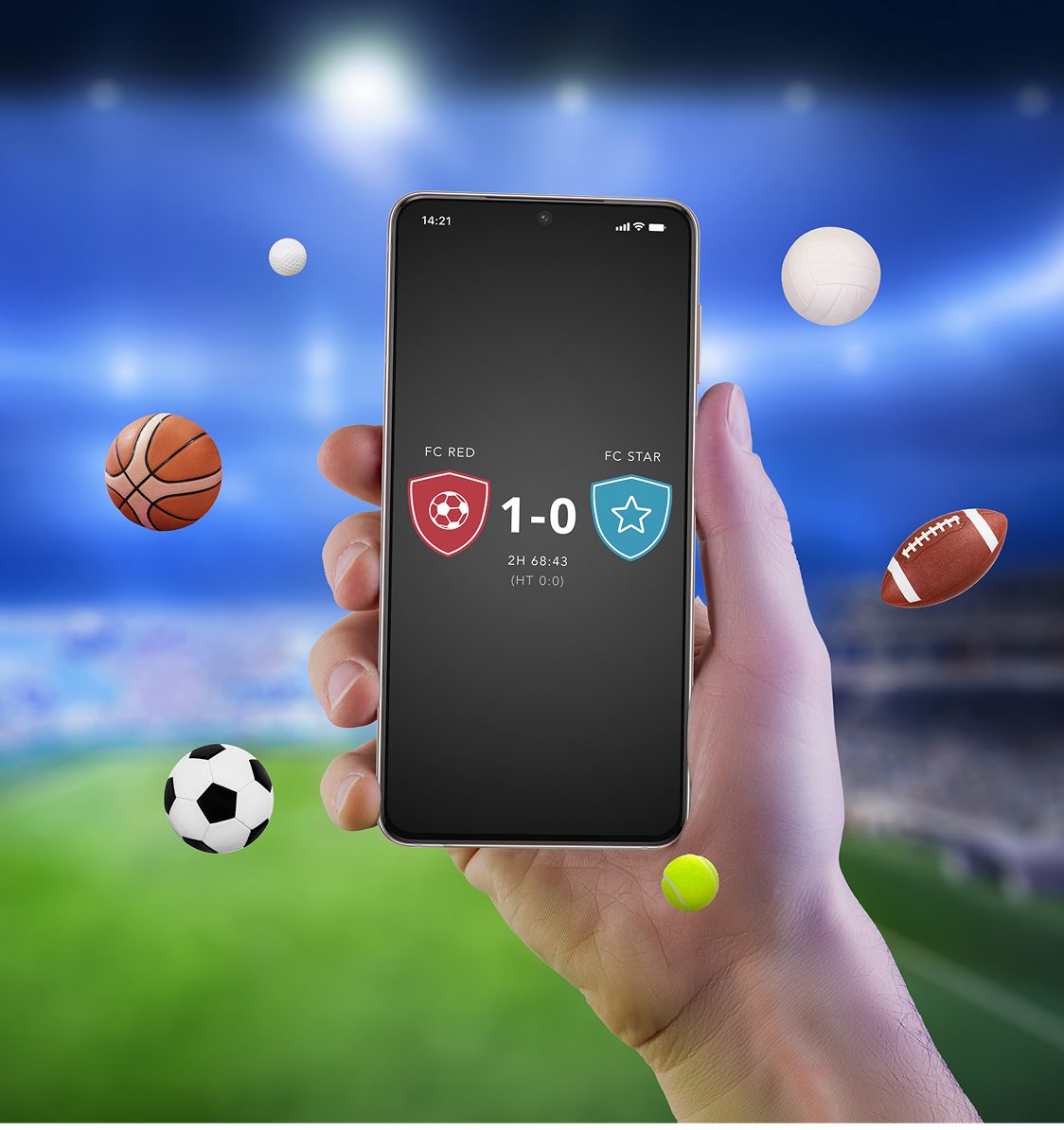 A hand holds a smartphone displaying a soccer score; various sports balls float around against a blurred stadium background.