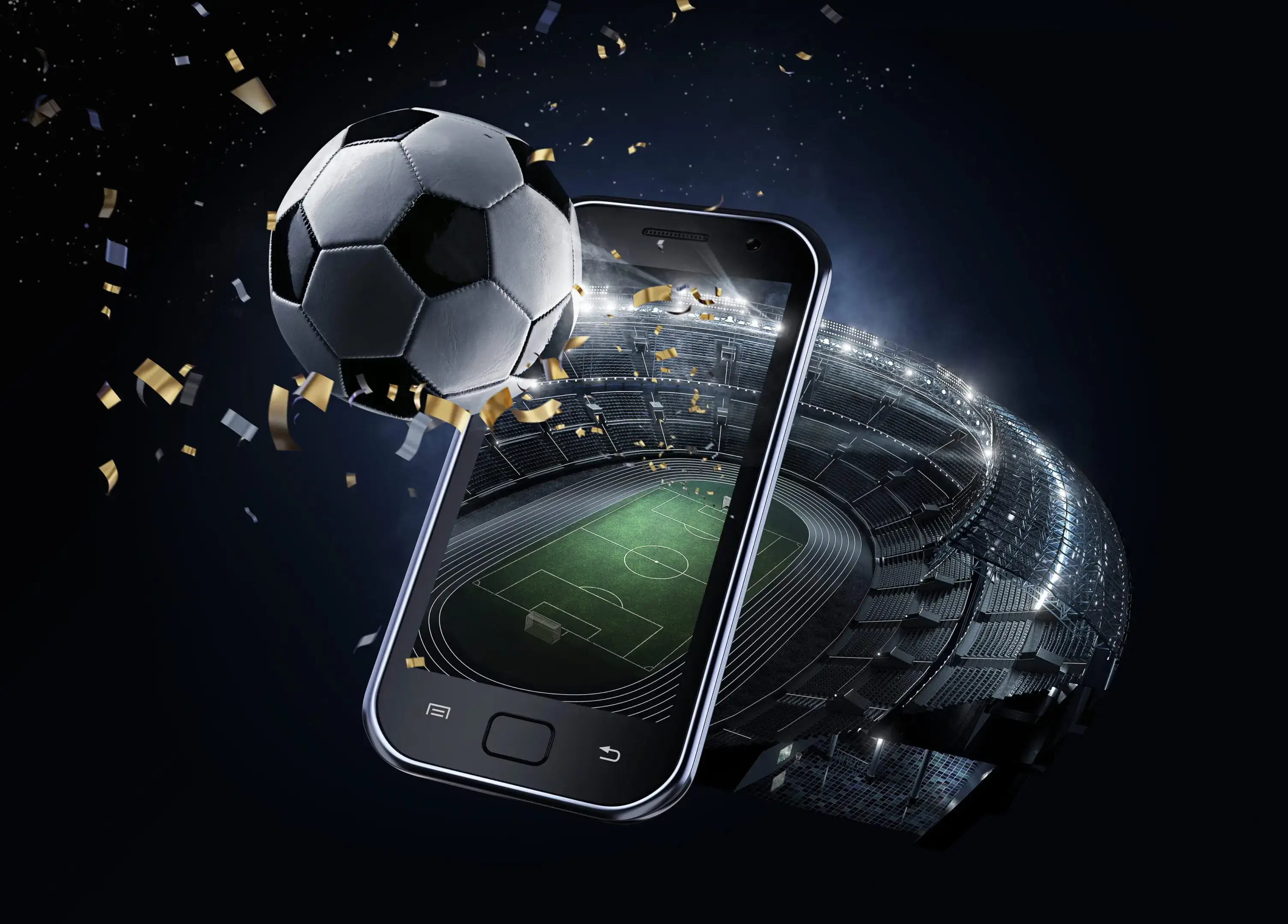 A soccer ball and confetti emerge from a smartphone screen in front of a brightly lit soccer stadium at night.
